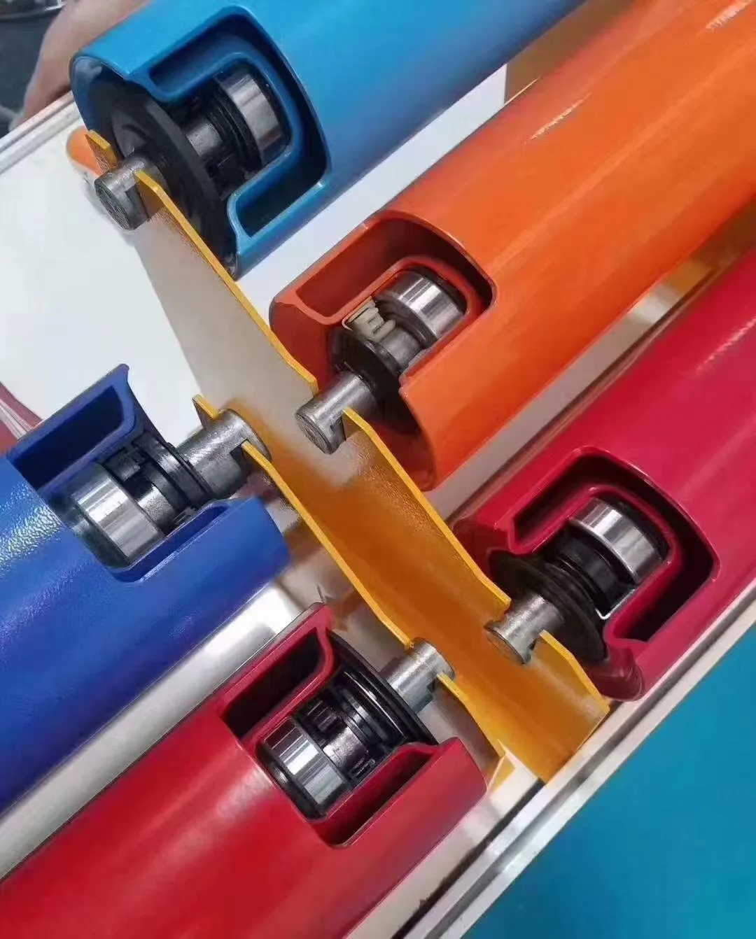 Cutaway conveyor rollers showing shaft and bearing components