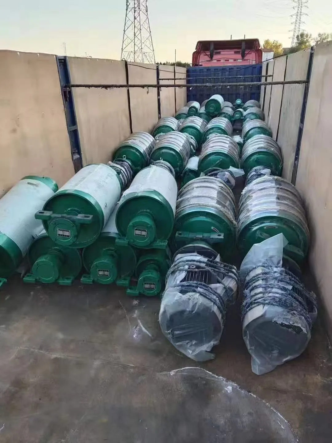 Green and silver cylindrical conveyor drive assemblies