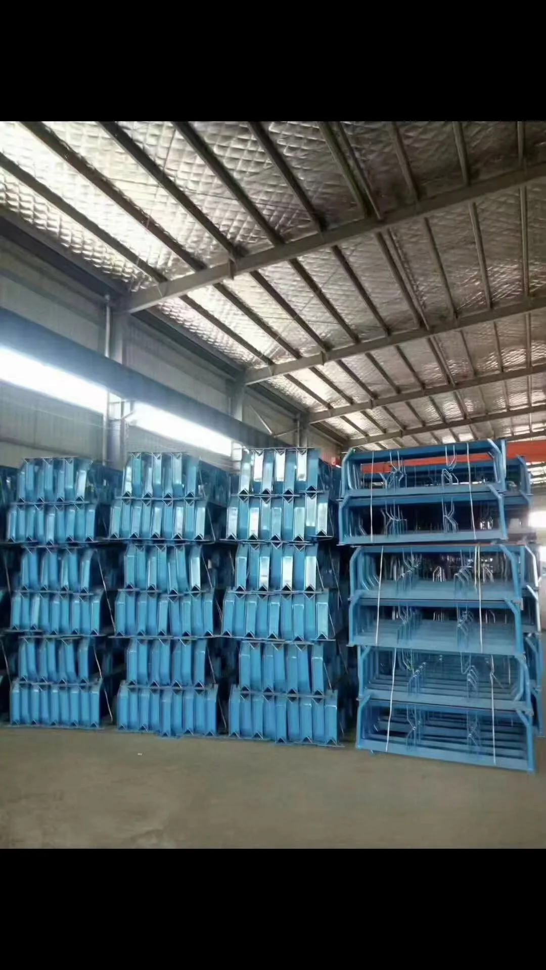 Blue conveyor components stored on warehouse racks