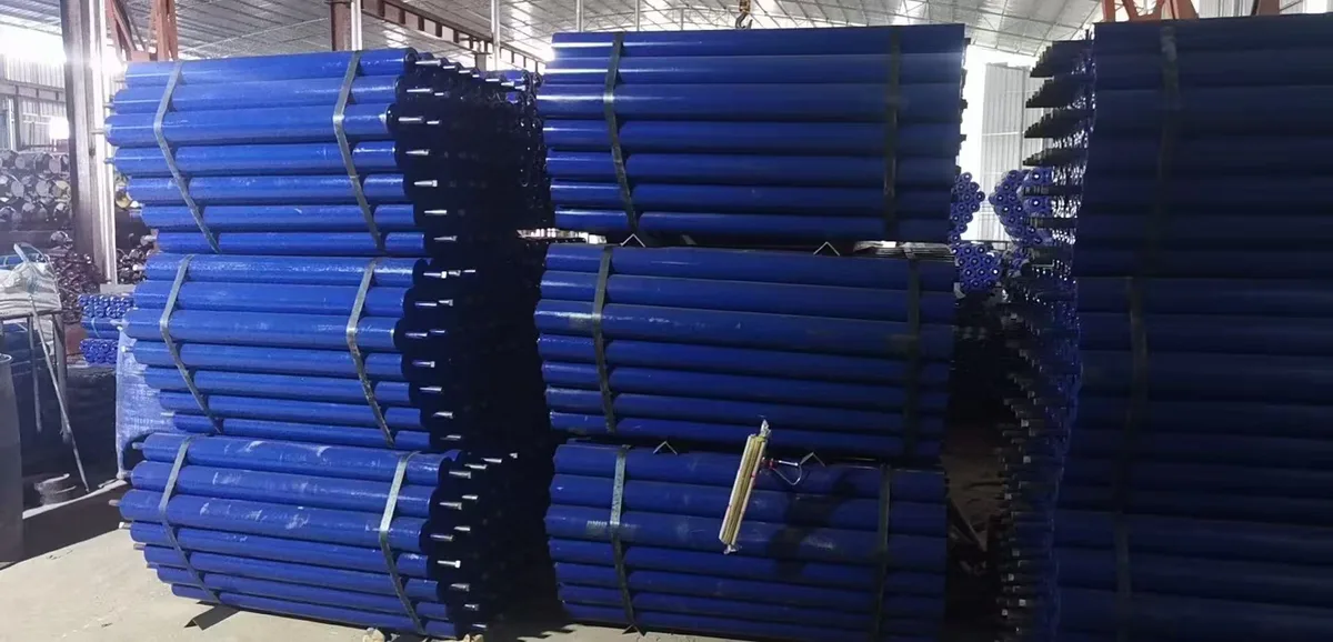 Blue conveyor rollers stacked in bundles